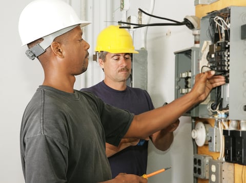 two electricians at panel