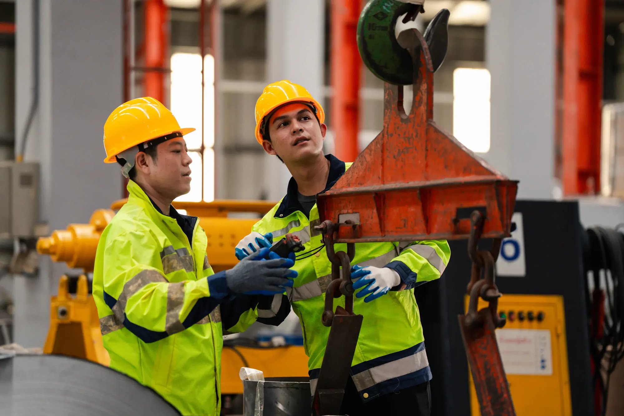 Two-construction-workers-assessing-equipment
