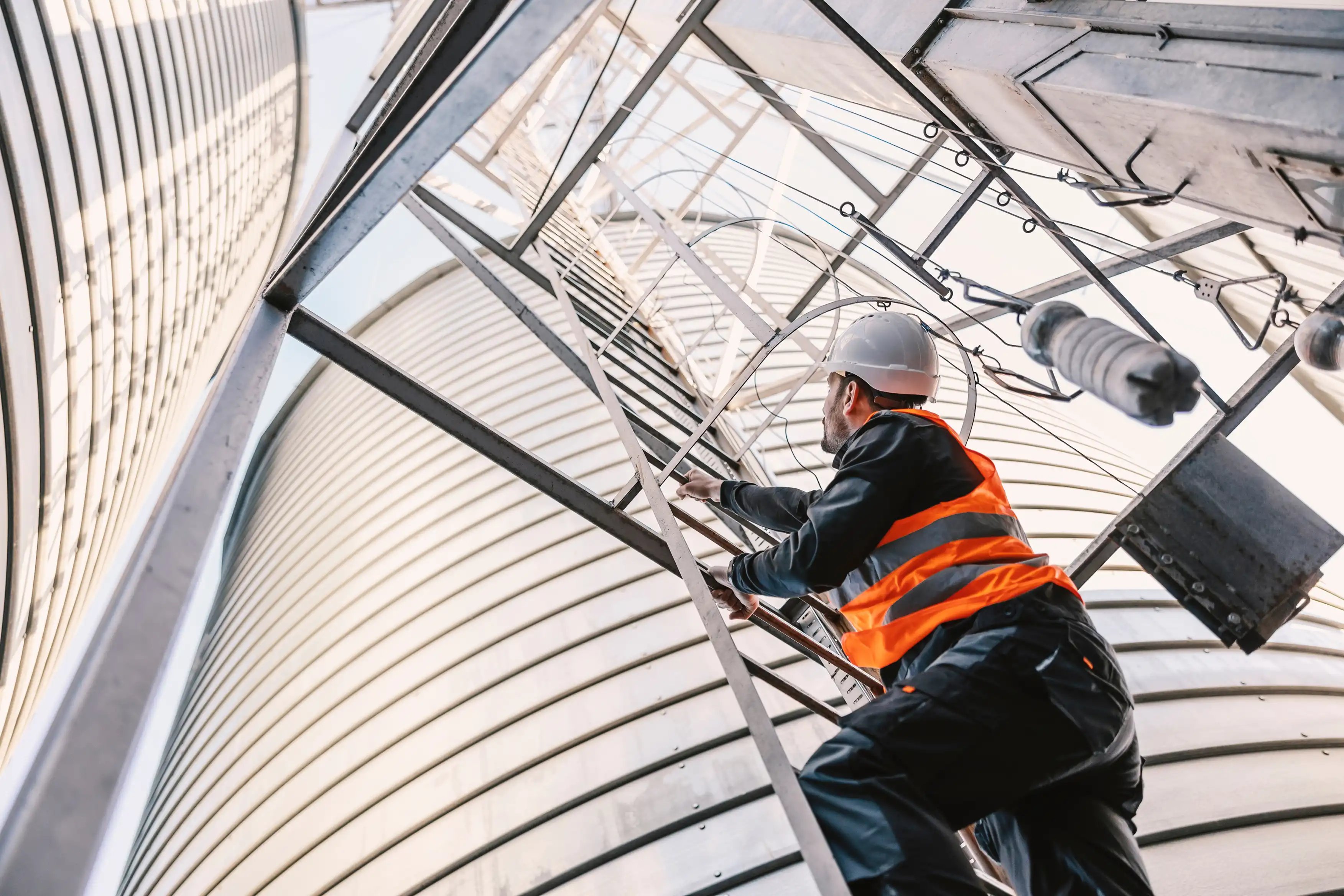 Worker-climbing-industrial-ladder