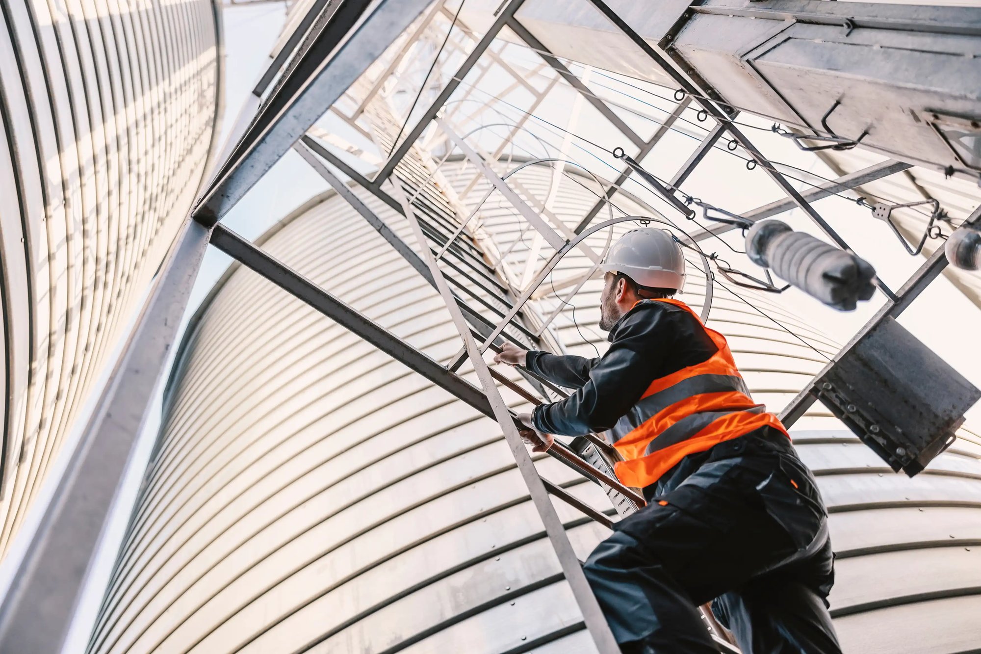 Worker-climbing-industrial-ladder