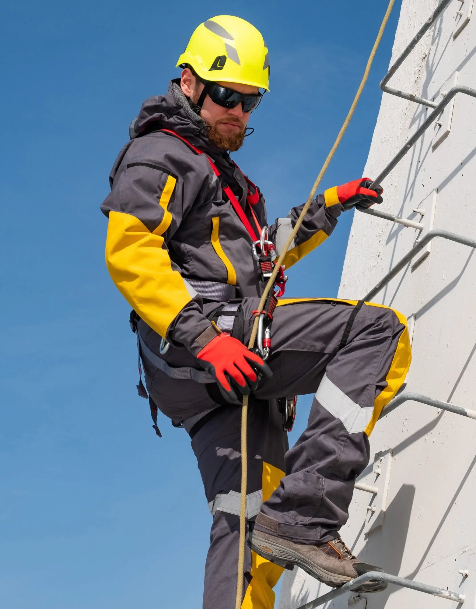 Worker-in-safety-gear-climbing